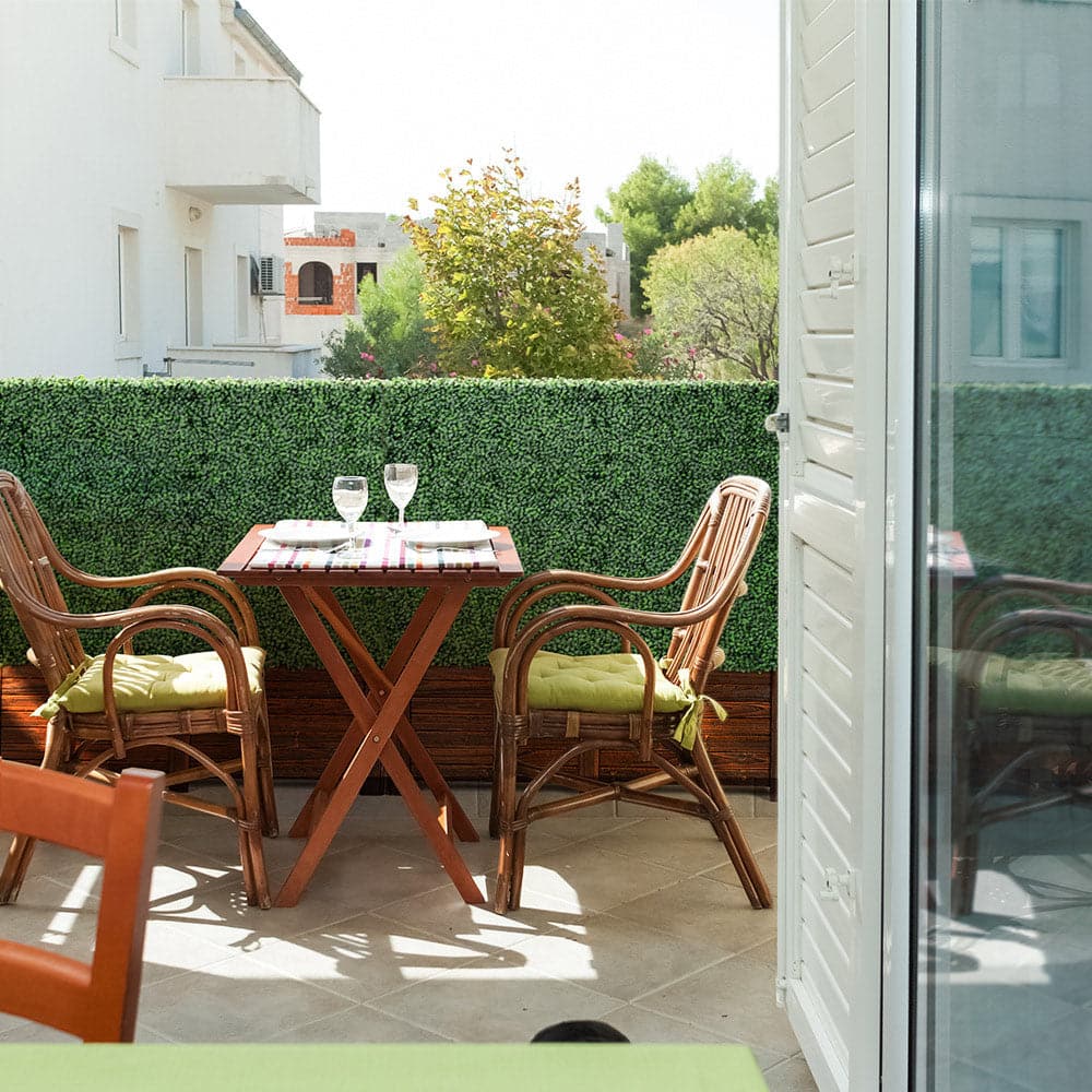 Artigwall's artificial boxwood hedge in wood planter on patio