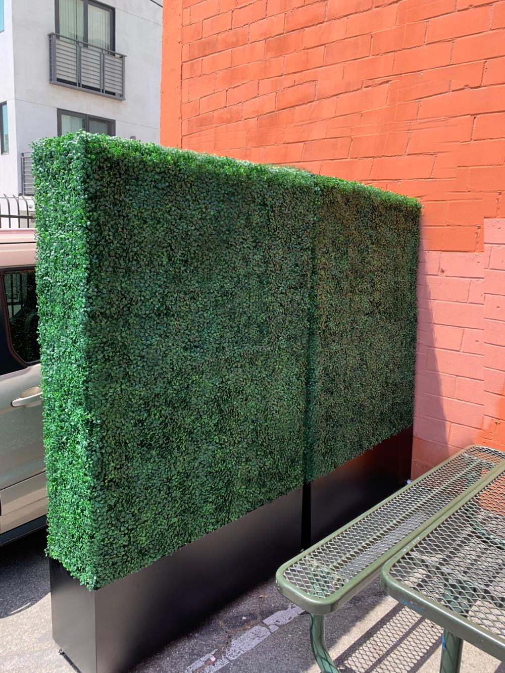 Artigwall artificial boxwood hedge wall on sidewalk near building
