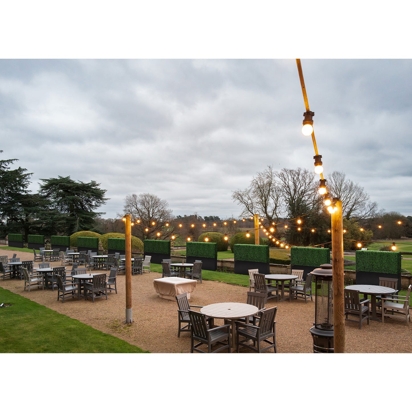 60-inch_faux_boxwood_hedge_wall_used_for_outdoor_restaurant