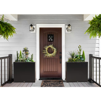 Large rectangular black metal planter box by Artigwall on front porch