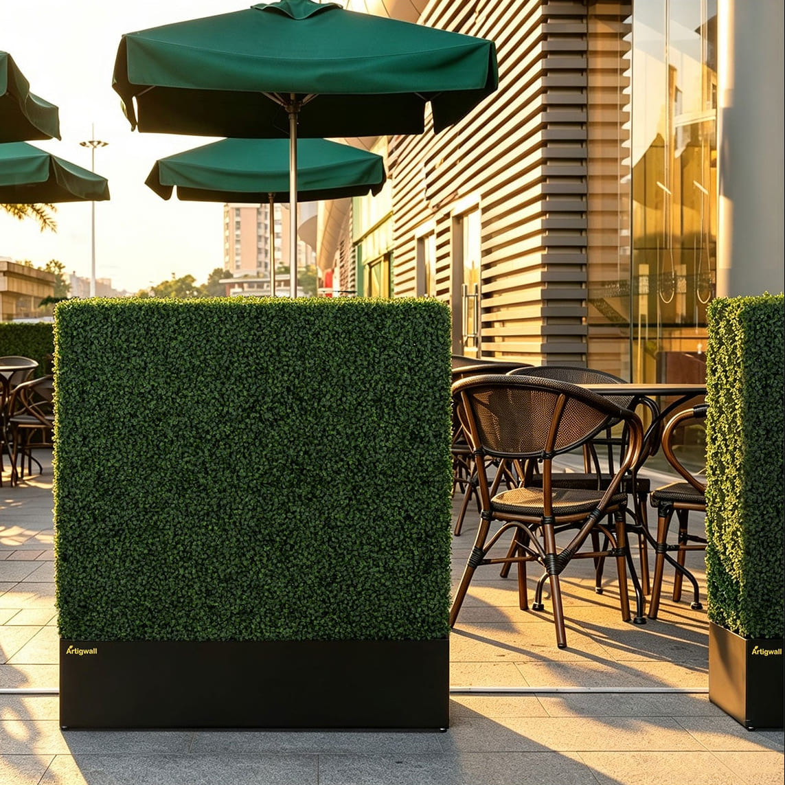 artificial_privacy_hedge_walls_create_privacy_beside_outdoor_sidewalk_dining