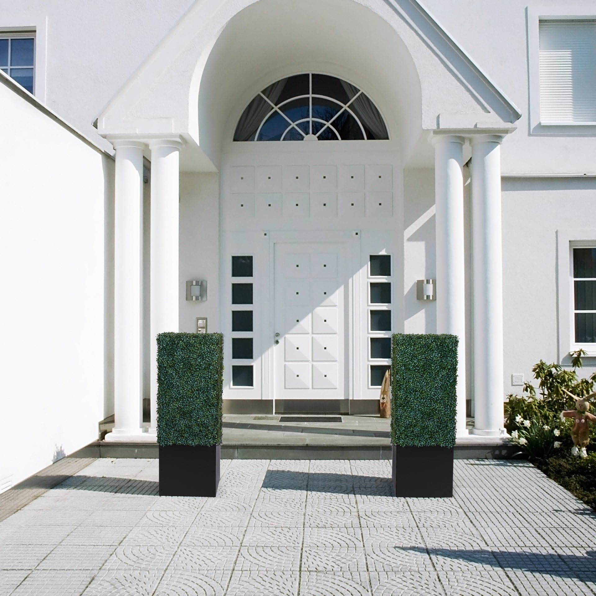 Artigwall boxwood topiary trees on walkway